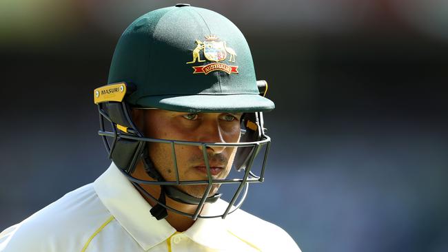 Usman Khawaja walks off after a disappointing 11 at the Gabba.