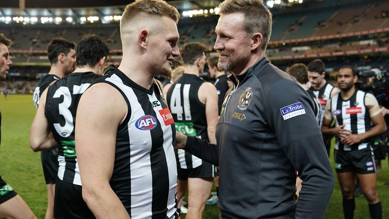 Adam Treloar and Collingwood coach Nathan Buckley.