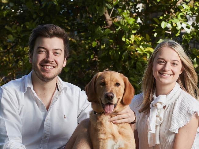 Jack Batty and Charlotte Thomas pose for a picture with their six month old dog Trooper in Eastwood, Sunday, Aug. 13, 2017. (AAP Image/MATT LOXTON)