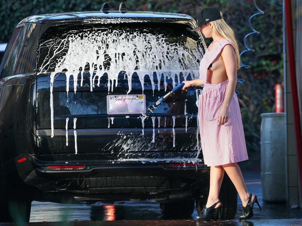 Choosing fashion over function, Addison completed the look with a pair of black high heels while she washed her car. Picture: Backgrid