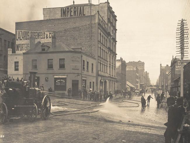 A street is hosed down as part of the mass cleansing efforts in January 1900. Picture: State Library of NSW