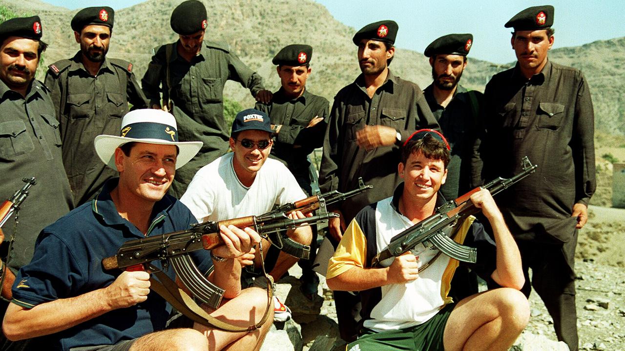 Steve Bernard, Justin Lange and Gavin Robertson holding AK-47 rifles.