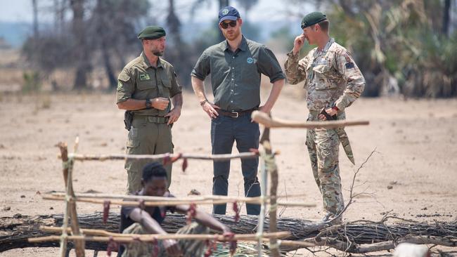 Prince Harry views a recreation of a poacher's camp, part of an anti-poaching demonstration exercise conducted jointly by local rangers and UK military, at the Liwonde National Park in Malawi, in 2019. Picture: Getty