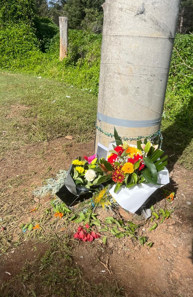 Flowers and tributes left at the site of a single-vehicle crash at Rochedale which resulted in the death of Charles 'CJ' Bishop on July 3.