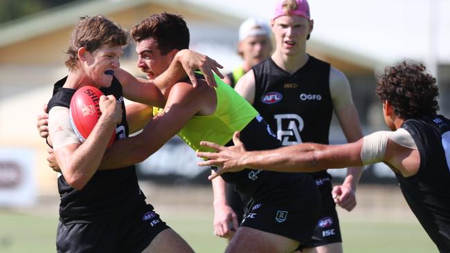 Mitch Georgiades is tackled by Scott Lycett at Port Adelaide training. Picture: TAIT SCHMAAL