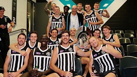 David Koch with Port Adelaide players wearing the prison bar guernseys.