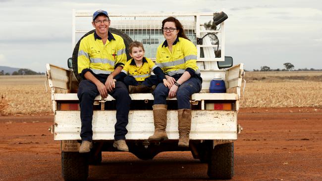 Farmers Mark and Katrina Swift with their son Henry, 4, on the family farm just outside of Forbes. Picture: Jonathan Ng