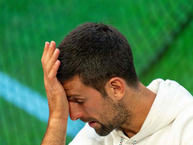 erbia's Novak Djokovic reacts as he speaks during a press conference in the Media Theatre at the Broadcast Centre following his defeat in the men's singles final tennis matchagainst Spain's Carlos Alcaraz on the last day of the 2023 Wimbledon Championships at The All England Tennis Club in Wimbledon, southwest London, on July 16, 2023. (Photo by Joe TOTH / various sources / AFP) / RESTRICTED TO EDITORIAL USE