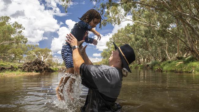 Emma Delahunty with son Banjo in the Todd River in Alice Springs. Picture: Emma Murray