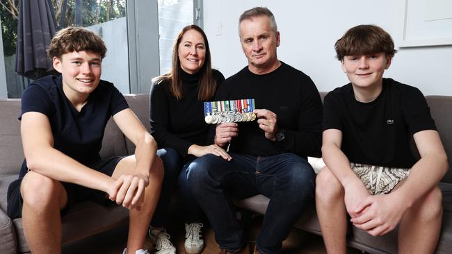 Veteran Paul Dunbavin, who has been diagnosed with a traumatic brain injury, with his wife Nicolle Hann-Dunbavin and sons Ky, 16, and Levi, 13. Picture: John Feder