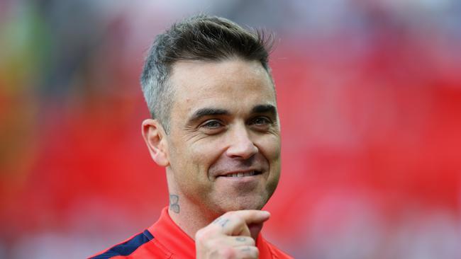 Hair supply: Robbie Williams admits bad dye jobs have seen him embrace the greys. Picture: Alex Livesey/Getty
