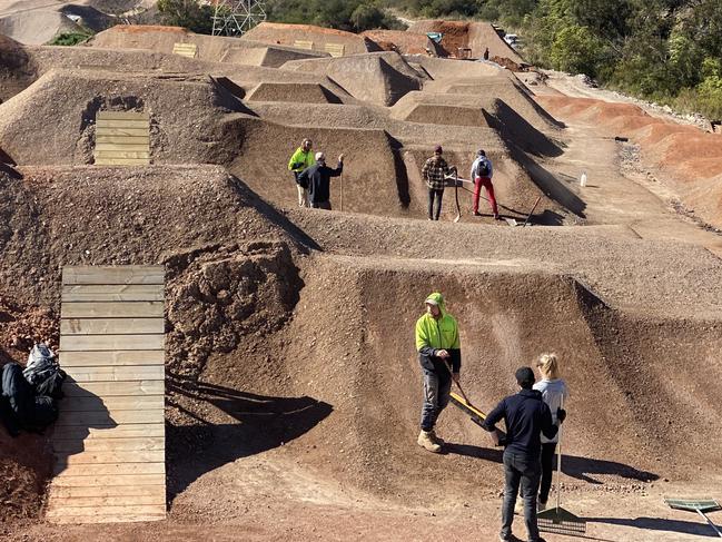 Local volunteers being trained by Dirt Art in trail maintenance activities at Belrose's new Bare Creek Park track. Picture: Trail Care/ Matthew Ward.