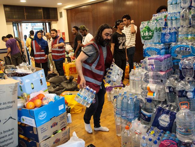 Drinks, food, clothes and bedding have been left at the grounds of the Westway Fitness Centre. Picture: Jack Taylor/Getty Images