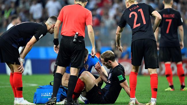 Croatia defender Ivan Strinic (centreC) receives medical assistance during the Russia 2018 World Cup semi-final football match against England. Photo: AFP