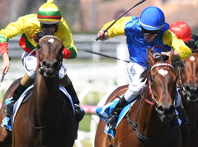 Jockey Brad Rawiller cracks the whip on Black Heart Bart (2nd R) to win the iTalktravel Futurity Stakes on Blue Diamond Stakes Day at Caulfield Racecourse in Melbourne, Saturday. Feb. 25, 2017. (AAP Image/Mal Fairclough) NO ARCHIVING, EDITORIAL USE ONLY