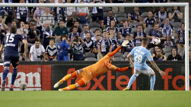 Jamie Maclaren beats Lawrence Thomas from the penalty spot. Picture: AAP