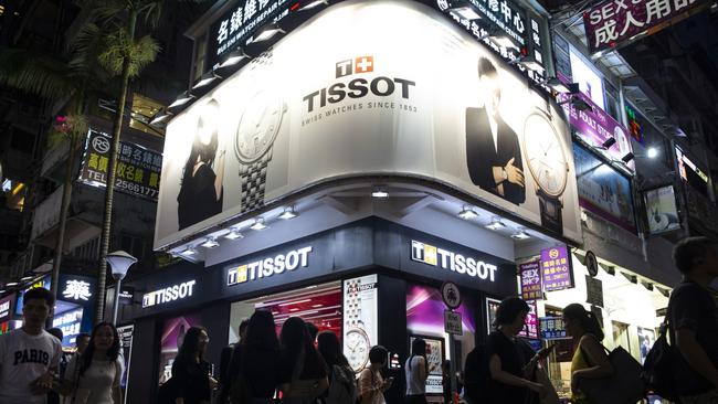 Pedestrians walk past a Tissot SA store in the Causeway Bay district of Hong Kong, China, on Thursday, Aug. 29, 2019. Whether it's glitzy shops in Central or decades-old family businesses along the city's winding streets, retailers of all levels across Hong Kong these days find themselves struggling in much the same way. Photographer: Chan Long Hei/Bloomberg