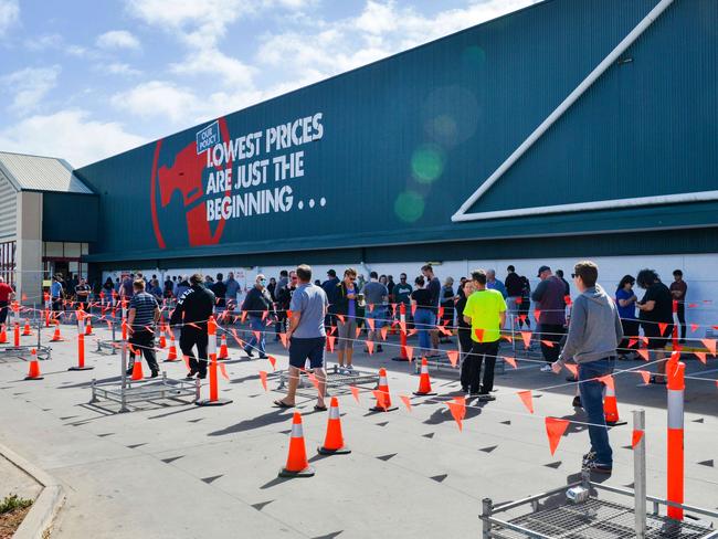 Lines of shoppers observing social distancing rules at Bunnings in Woodville. Picture: Brenton Edwards