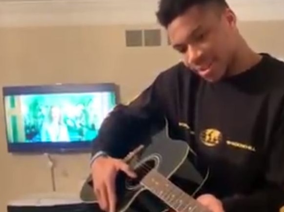 Giannis Antetokounmpo playing guitar on NBA break