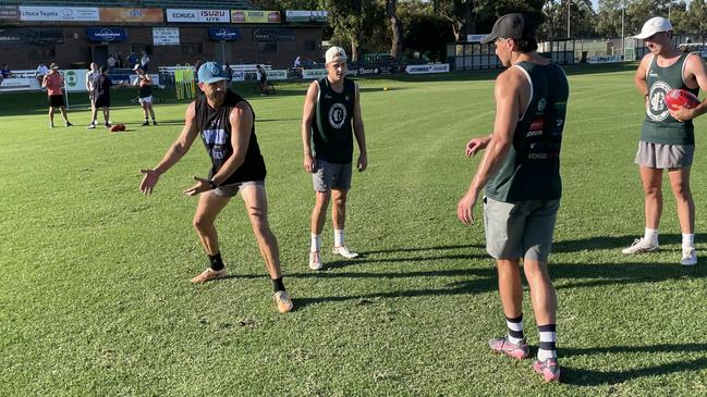 Sam Reid (left) guides Echuca teammates through a drill. Picture: Shane Jones.