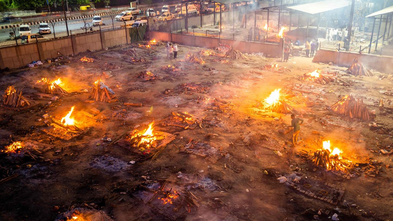 Men are seen around the burning pyres of those who lost their lives due to COVID-19 at a cremation ground in New Delhi on April 26. Picture: Jewel Samad/AFP