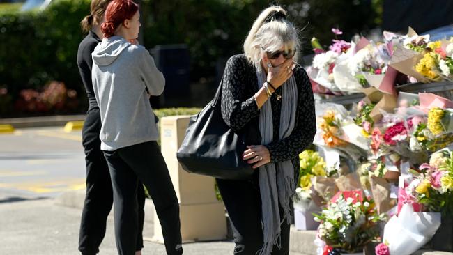 Members of the community arrive to lay a floral tribute where paramedic Steven Tougher was killed on Friday.Picture: NCA NewsWire / Jeremy Piper