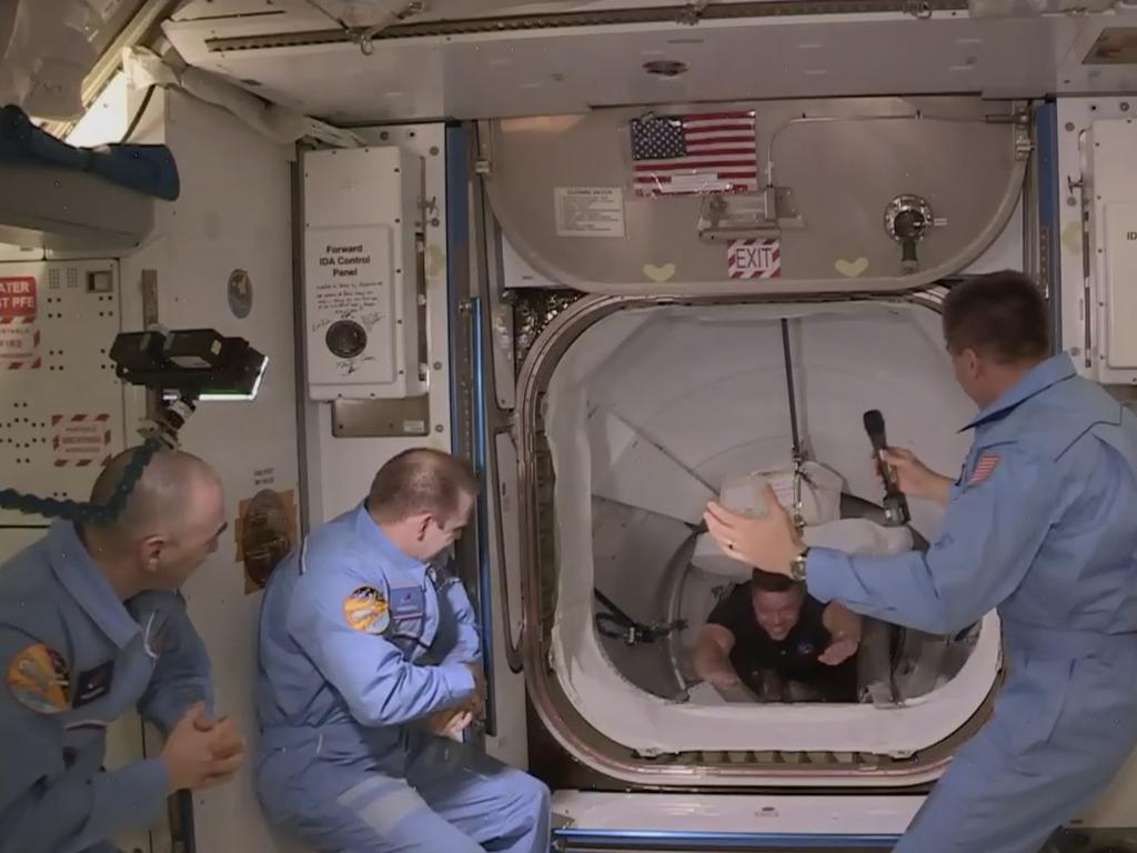 This photo provided by NASA shows the crew of SpaceX entering the International Space Station, Sunday, May 31, 2020.  The Dragon capsule arrived Sunday morning, hours after a historic liftoff from Florida. It's the first time that a privately built and owned spacecraft has delivered a crew to the orbiting lab. (NASA via AP)