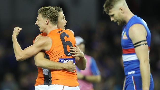 Lachie Whitfield celebrates a goal as Jake Stringer as his head down. Picture: AAP