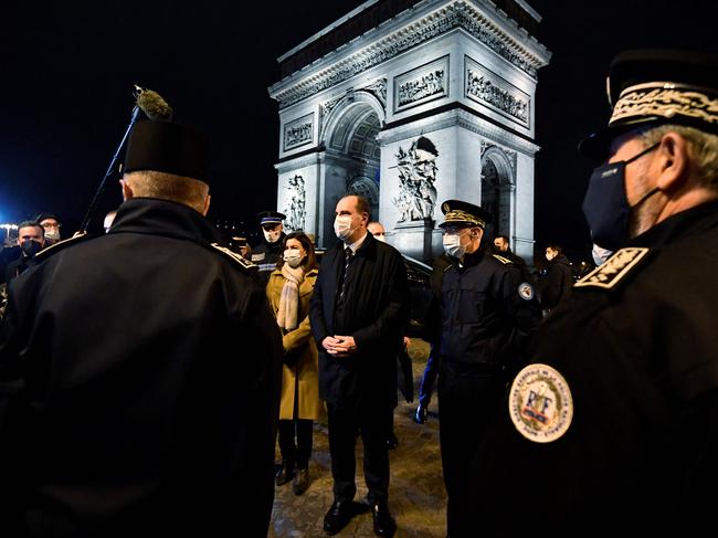 French Prime Minister Jean Castex (C), flanked by Paris Mayor Anne Hidalgo (L) and Paris Prefect Didier Lallement (R), meets police officers on the New Year's Eve, in Paris, on December 31, 2021. Picture: AFP