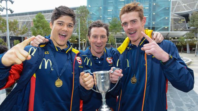 Tony Bamford and players Tom Lewis and Jez McLennan with the under 18 trophy. Picture: Brenton Edwards/AAP