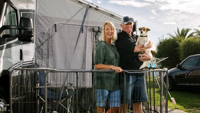 On-road travellers Karen and Colin Jackson with dog Saxton, pictured at the Discovery Parks in Semaphore in Adelaide, can’t wait to get back on the road. Picture: Morgan Sette.