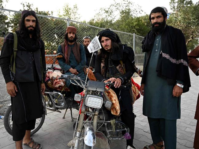 Taliban fighters stand along a road in Kabul yesterday. Picture: AFP