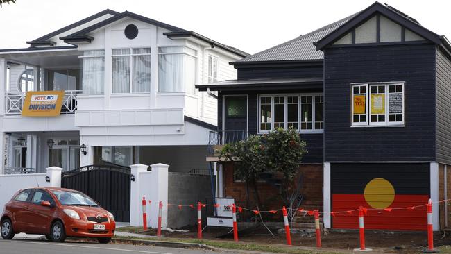 Two neighbouring houses in the bayside suburb of Wynnum in Brisbane are showing 'Yes' and 'No' signage ahead of the referendum. Picture: NCA NewsWire/Tertius Pickard