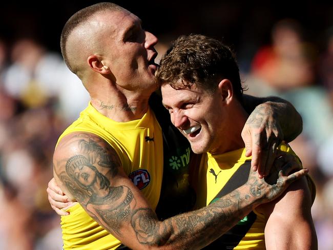 ADELAIDE, AUSTRALIA - MARCH 25: Jacob Hopper and Dustin Martin of the Tigers celebrate a goal during the 2023 AFL Round 02 match between the Adelaide Crows and the Richmond Tigers at Adelaide Oval on March 25, 2023 in Adelaide, Australia. (Photo by James Elsby/AFL Photos via Getty Images)