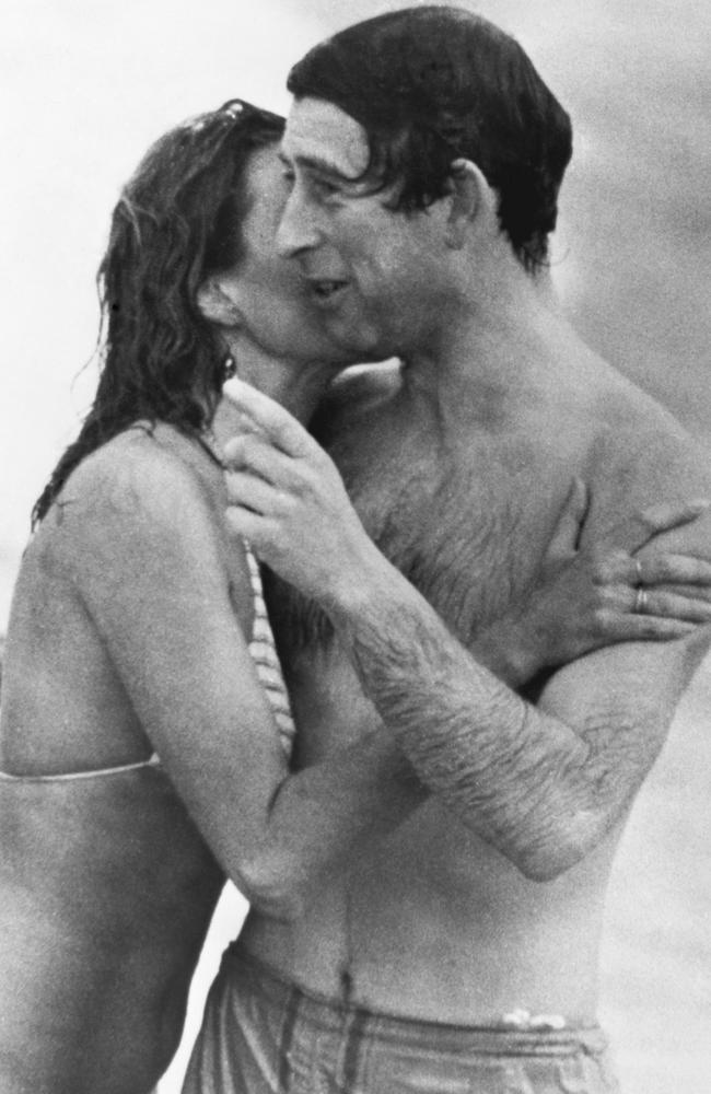 Prince Charles is kissed by Jane Priest, a model, as he emerges from the water at Cottesloe beach in Perth, during his 1979 tour of Australia. Picture: Getty Images