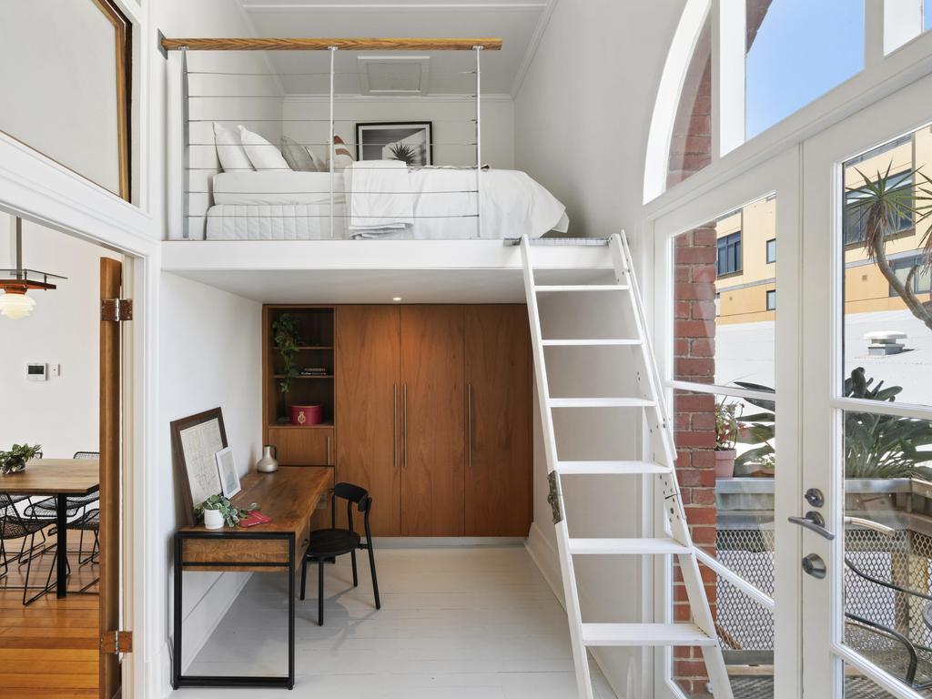 French doors open to a sunlit balcony in converted tram depot.