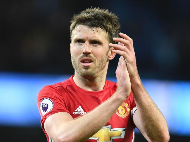 (FILES) This file photo taken on April 27, 2017 shows Manchester United's English midfielder Michael Carrick applauding their fans at the end of the English Premier League football match between Manchester City and Manchester United at the Etihad Stadium in Manchester, north west England, on April 27, 2017. Manchester United's Michael Carrick's rallying call 'We'll stay together and stay strong' summed up the sporting world's response Sunday to the latest terror outrage that left seven dead and dozens injured in London. / AFP PHOTO / Paul ELLIS / RESTRICTED TO EDITORIAL USE. No use with unauthorized audio, video, data, fixture lists, club/league logos or 'live' services. Online in-match use limited to 75 images, no video emulation. No use in betting, games or single club/league/player publications.  /