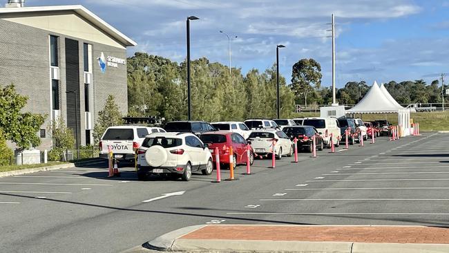 Vehicles lined up at the Hervey Bay fever clinic on Friday.