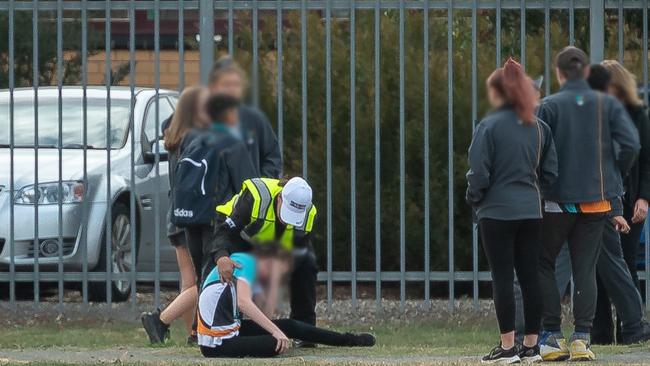 A student is helped off the ground after he was attacked at Greater Shepparton Secondary School’s McGuire campus. Picture: Jason Edwards