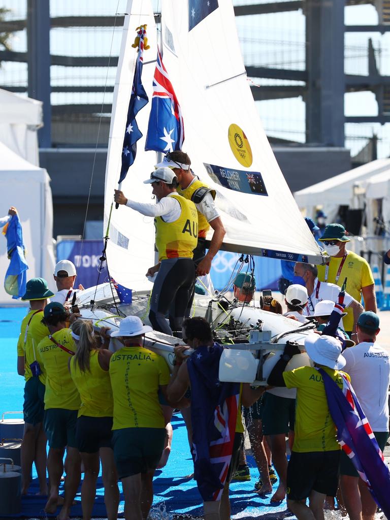 The Aussie team chairs off the gold medallists. Picture: Clive Mason/Getty