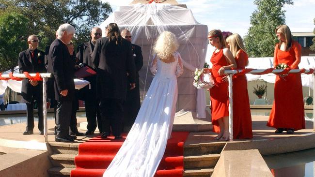 Stormy Summers with husband Mark "Markie G" Garner in Light Square at their wedding in front of plinth of Colonel Light's theodolite.