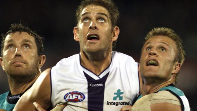 Premiership double act Brendon Lade and Dean Brogan double up on Aaron Sandilands in 2009.