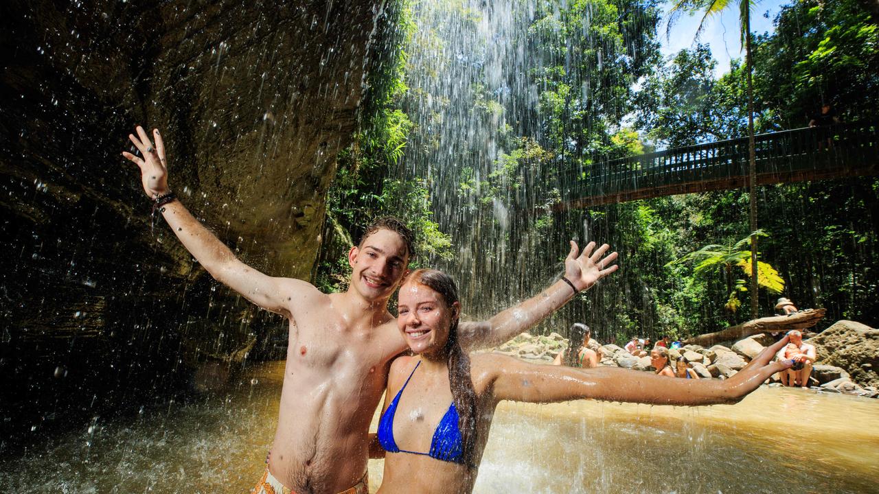 Elise Smith 17, and Josh Neville 18, from Brisbane beat the heat with a dip at Buderim Falls on the Sunshine Coast. Picture: Lachie Millard