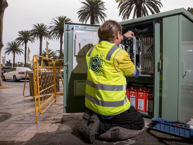 An NBN Co. technician handles hardware in a fibre distribution cabinet in Sydney. Picture: Cole Bennetts