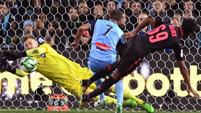 Sydney FC goalkeeper Andrew Redmayne saves a shot from Arsenal’s Joe Willock.