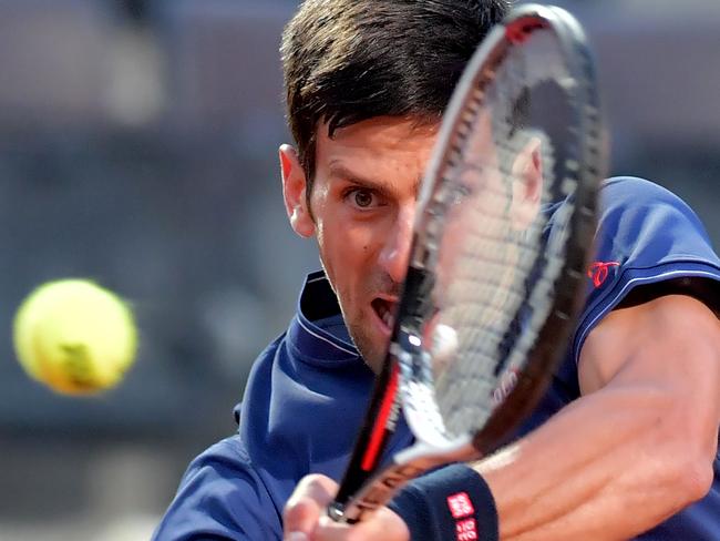 Novak Djokovic of Serbia hits a return during the semi-final match against Dominic Thiem of Austria at the ATP Tennis Open tournament, on May 20, 2017 at the Foro Italico in Rome. / AFP PHOTO / TIZIANA FABI