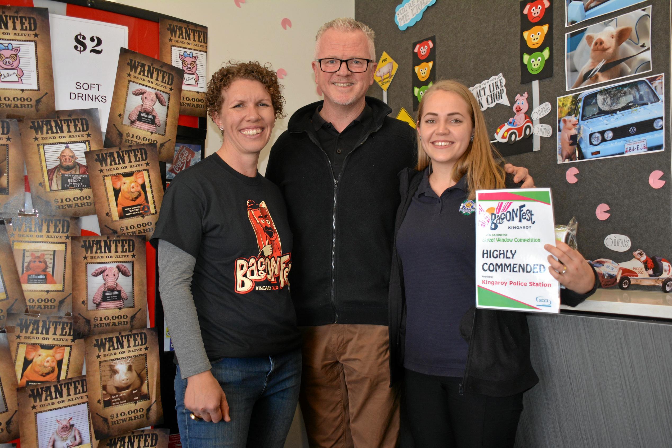 WANTED: Baconeers Kath Stevens and Rob Fitz-Herbert, with admin officer Emmy Cooper at the Kingaroy Police station with their BaconFest street window display which earned a highly commended. Picture: Jessica McGrath