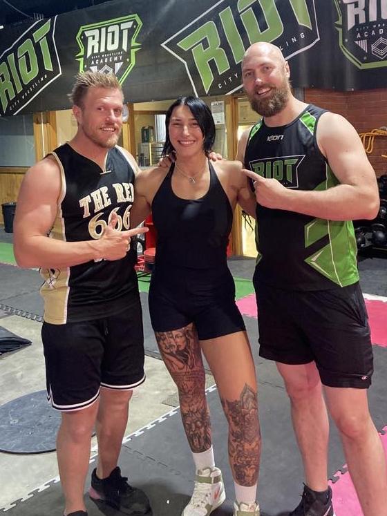 Riot City Wrestling founders Chris Basso (left) and Matt Basso (right) with WWE superstar Rhea Ripley (Demi Bennett) who has gone on to global stardom after being trained by the Bassos in Adelaide. Picture: Riot City Wrestling