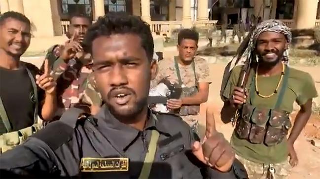 This image grab from social media video shows Sudanese volunteers celebrating the regular army's recapture of the presidential palace in Khartoum.