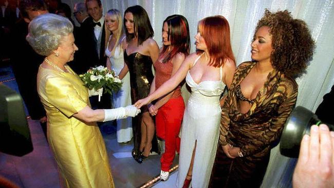 The Queen Elizabeth II shakes hands with Geri Halliwell (Ginger Spice) of the pop group Spice Girls. Picture: AFP